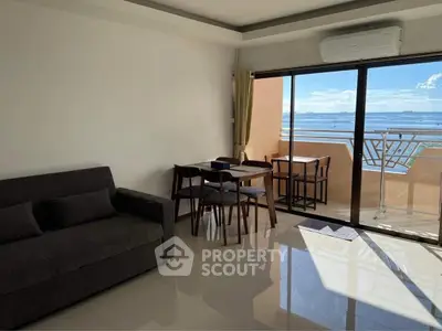 Modern living room with balcony and stunning sea view, featuring sleek furniture and air conditioning.