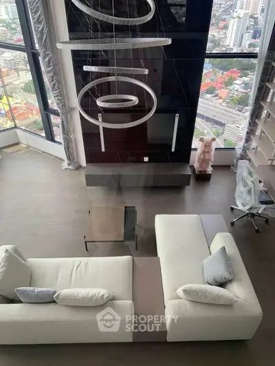 Luxurious high-rise living room with stunning city view and modern furnishings.