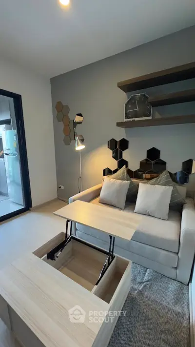 Modern living room with stylish furniture and geometric wall decor