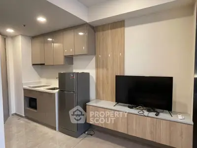 Modern kitchen with sleek cabinetry and integrated appliances in a stylish apartment.