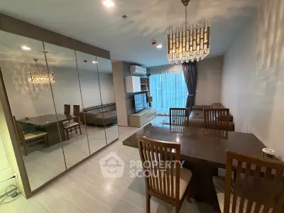 Spacious modern living room with elegant dining area and mirrored wall