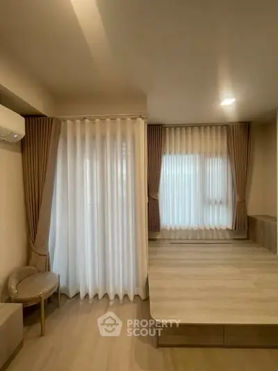Spacious bedroom with elegant curtains and modern design