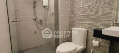 Modern bathroom with sleek shower and toilet in contemporary design.