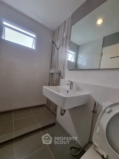 Modern bathroom with sleek sink and shower area