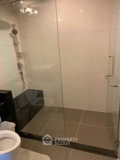 Modern bathroom with glass shower enclosure and sleek fixtures
