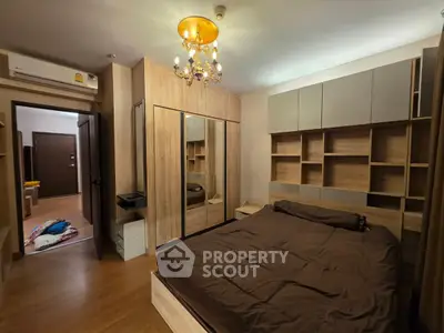 Cozy bedroom with elegant chandelier and mirrored wardrobe