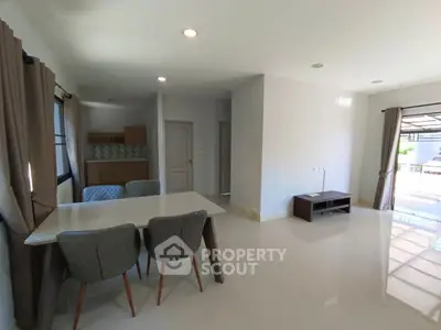 Spacious modern living room with dining area and large windows
