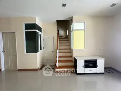Spacious modern interior with staircase and sleek flooring