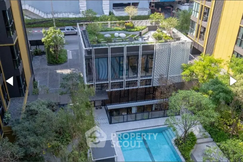 Modern urban apartment complex with rooftop garden and pool view.