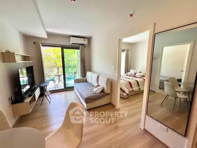 Modern living room with balcony access and cozy bedroom view