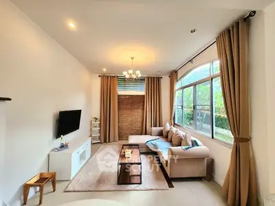 Spacious living room with modern decor and large windows for natural light.