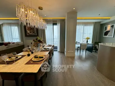 Luxurious dining and living area with elegant chandelier and city view