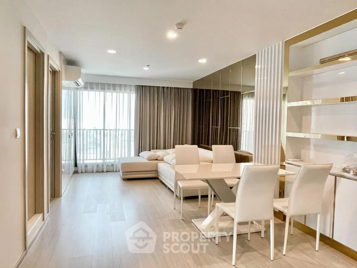 Modern living room with elegant dining area and large windows