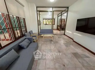 Spacious living room with modern furniture and large windows for natural light.