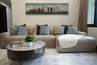 Modern living room with stylish sofa and cityscape artwork, perfect for urban living.