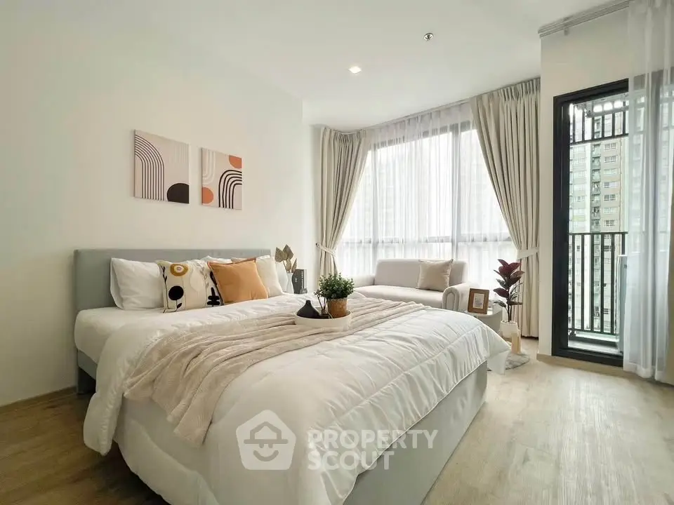 Modern bedroom with cozy decor and large windows in a stylish apartment