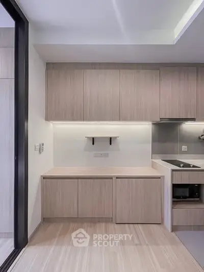 Modern kitchen with sleek cabinetry and built-in appliances in a contemporary apartment.