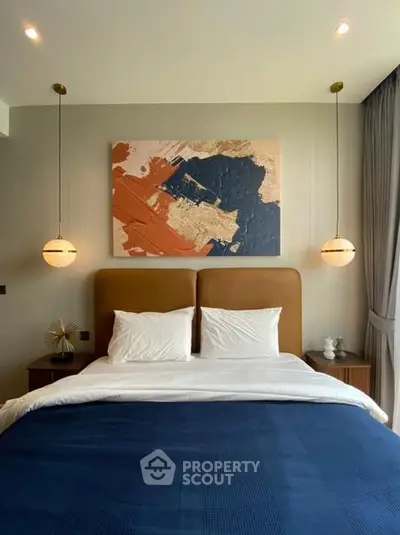 Luxurious bedroom with modern art and elegant lighting, perfect for a serene retreat.