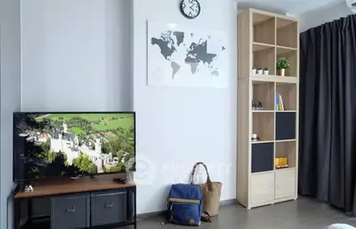 Modern living room with stylish shelving and wall-mounted TV, perfect for cozy relaxation.