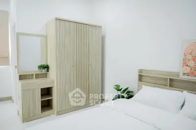 Modern bedroom with minimalist wooden furniture and white bedding