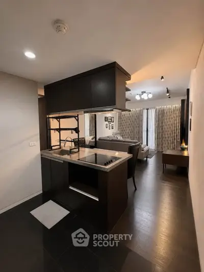 Modern open-layout kitchen with sleek design and cozy living area, perfect for urban living.