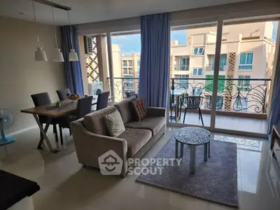 Spacious living room with modern decor and balcony view in a stylish apartment.