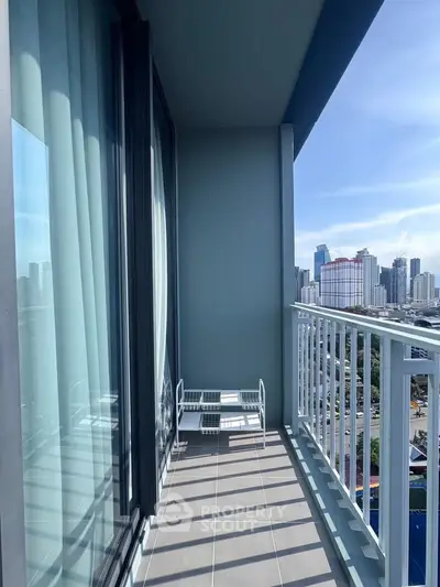 Spacious balcony with stunning city skyline view, perfect for relaxation and enjoying urban living.