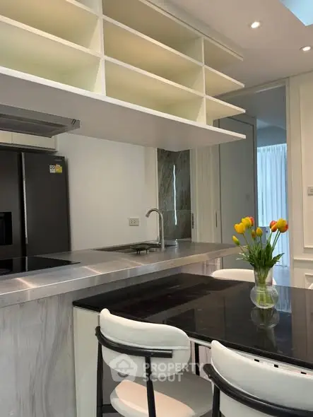 Modern kitchen with sleek design, featuring stainless steel appliances and elegant dining area.
