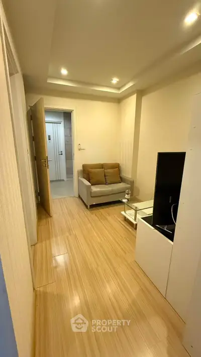 Cozy living room with modern decor and wooden flooring, perfect for relaxation.