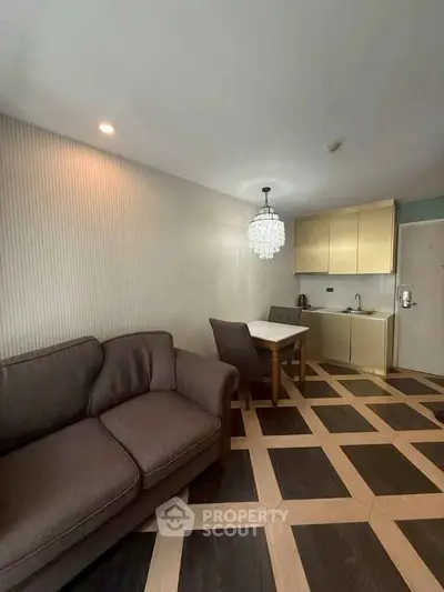 Modern living room with stylish flooring and compact kitchen area