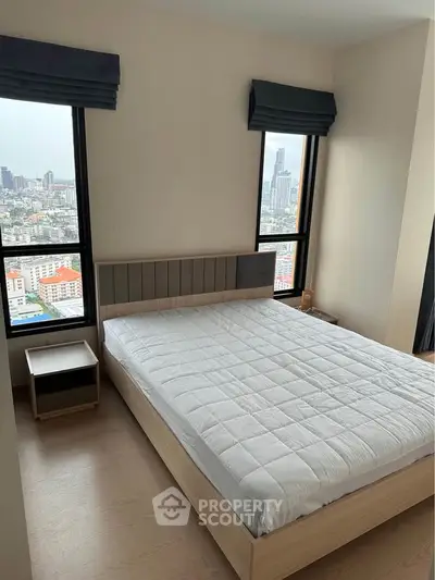 Modern bedroom with city view, featuring large windows and minimalist design.