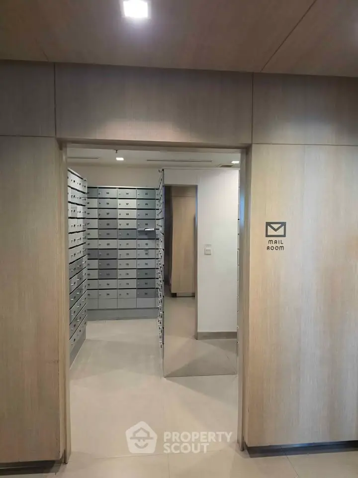 Modern mail room with sleek design and ample storage in a residential building.