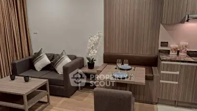 Modern living room with cozy seating and stylish kitchen area