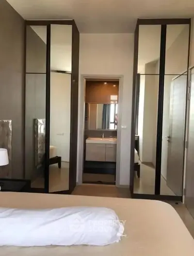 Modern bedroom with mirrored wardrobes and ensuite bathroom