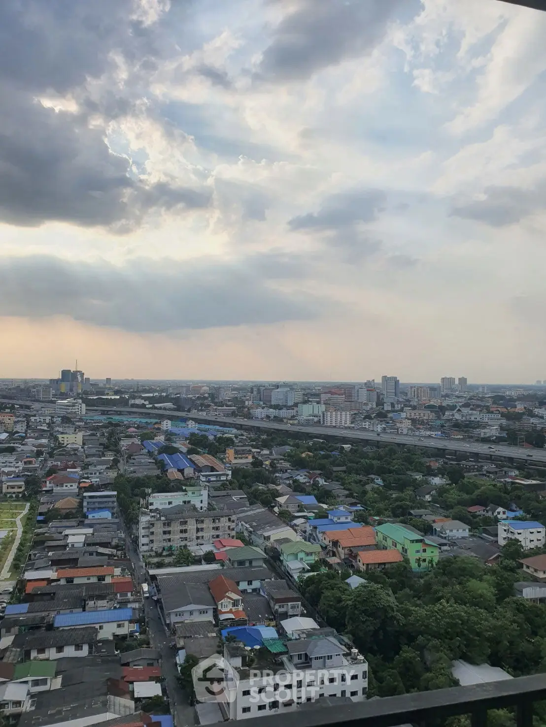 Stunning cityscape view from high-rise balcony showcasing urban skyline and vibrant neighborhood.