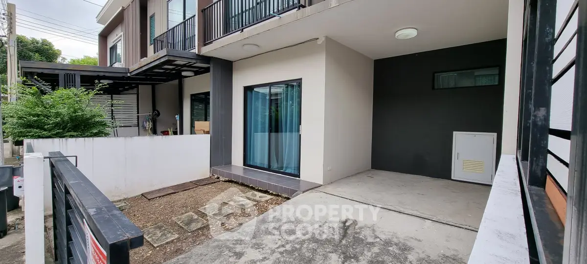 Modern townhouse exterior with private parking and sleek design