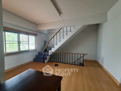 Spacious interior with wooden flooring and staircase, ideal for modern living.