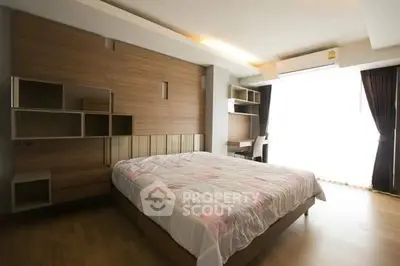 Spacious modern bedroom with stylish wooden accents and natural light