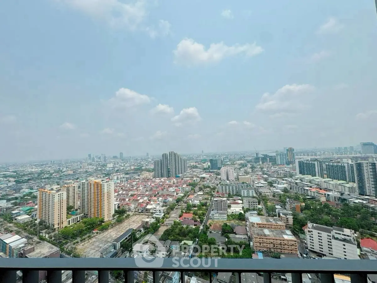 Stunning cityscape view from high-rise balcony showcasing urban skyline and expansive horizon.