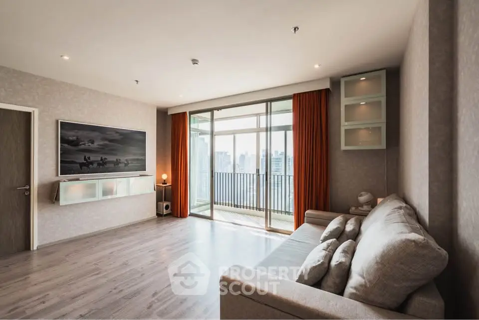 Spacious modern living room with balcony and city view