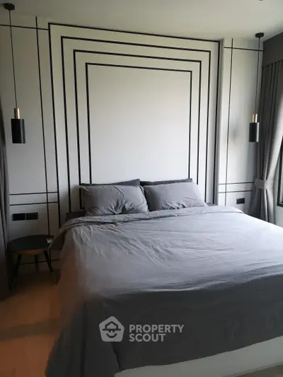 Modern bedroom with stylish decor and cozy bedding in a contemporary apartment.
