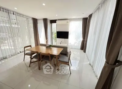 Spacious dining area with modern furniture and large windows for natural light