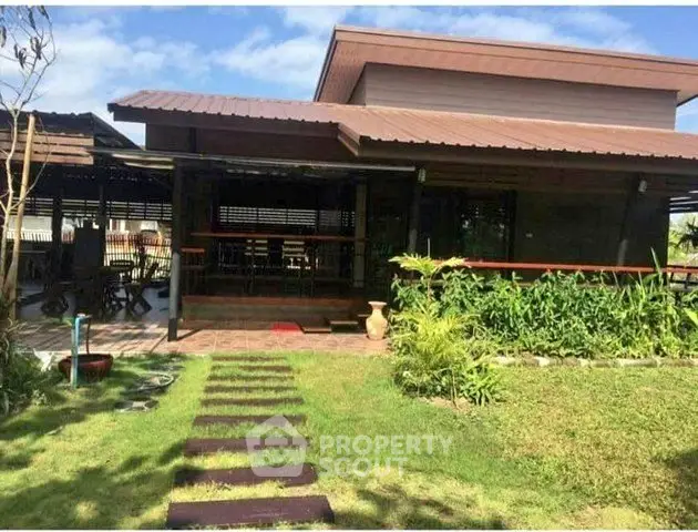 Charming wooden house with lush garden and inviting outdoor space, perfect for relaxation and entertaining.