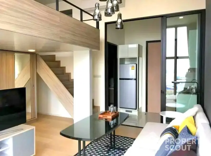 Modern loft-style living room with mezzanine and sleek kitchen area