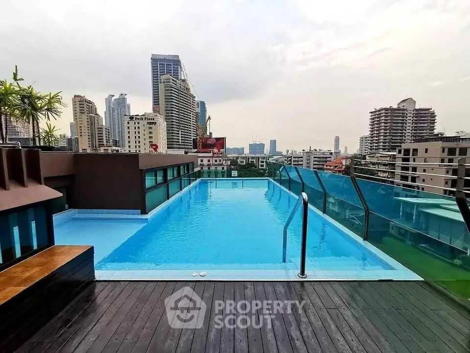 Stunning rooftop pool with panoramic city views in a modern urban setting.