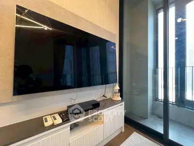 Modern living room with large TV and balcony view in luxury apartment