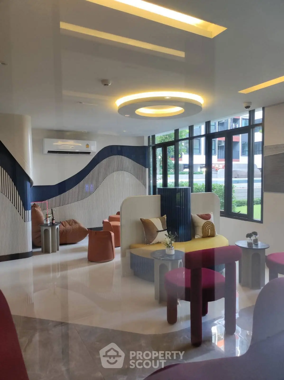 Modern living room with stylish furniture and large windows offering natural light