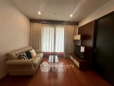 Cozy living room with elegant sofa and modern entertainment unit, perfect for relaxation.