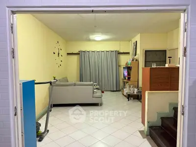 Cozy living room with modern sofa and entertainment center, perfect for relaxation and family gatherings.