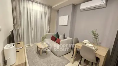 Cozy modern living room with air conditioning and dining area, perfect for urban living.